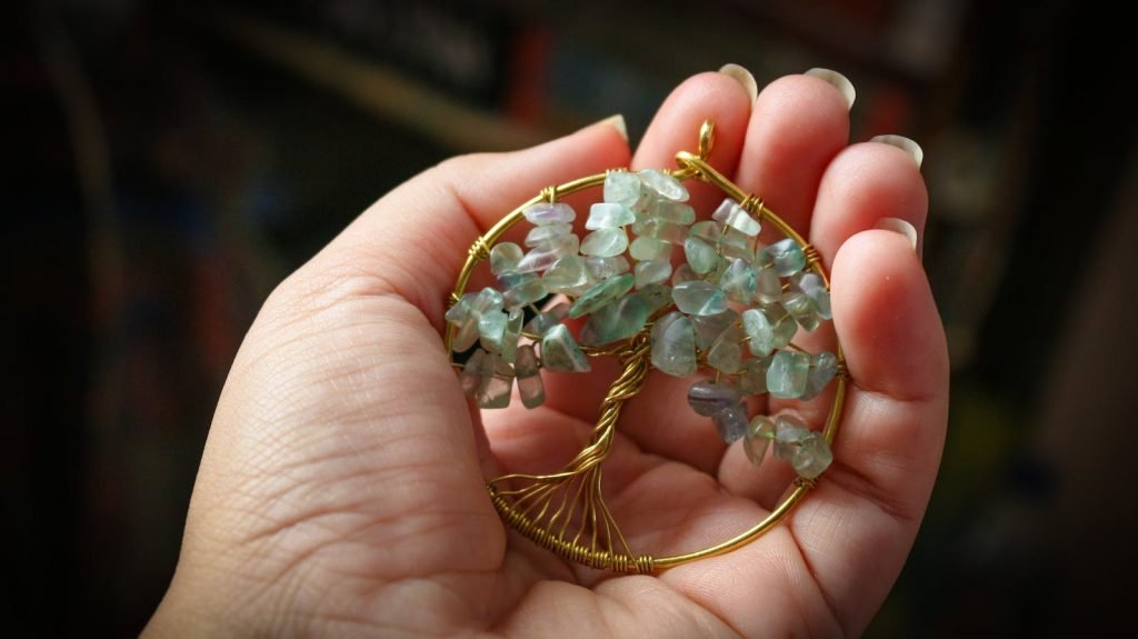 Woman Holding a Tree of Life Pendant in her Hand