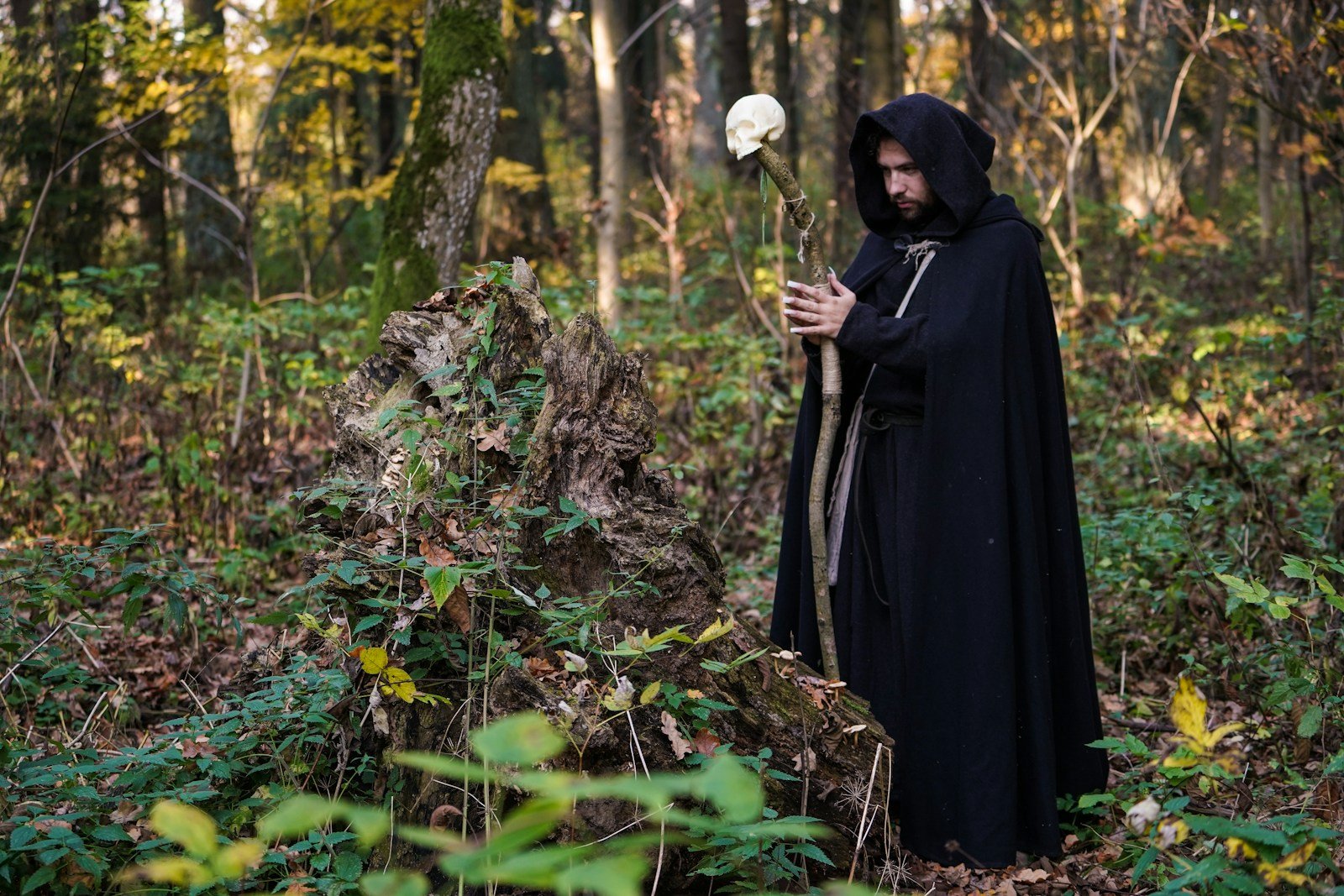 man wearing cloak and holding a wooden cane with white skull ornament, Book of Abramelin